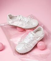 Zapatos planos informales con tiras cruzadas y lazo de piel sintética color rosa